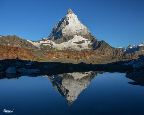 Matterhorn reflected in an alpine lake in Switzerland. 