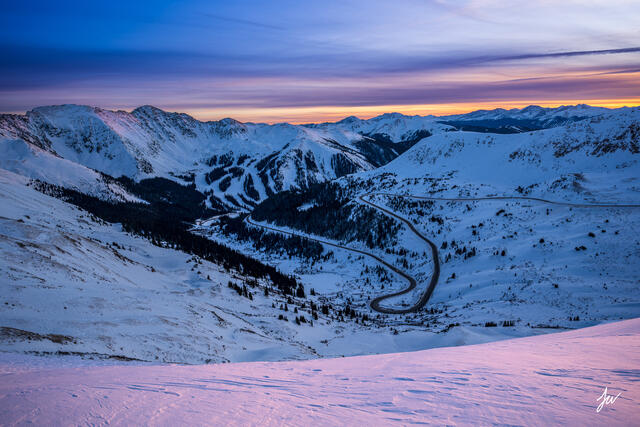 Colorado ski resorts — Arapahoe Basin in the foreground with Keystone and Breckenridge in the background, snowy Rocky Mountains.