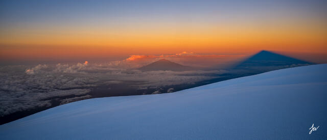 Sunrise view of Mount Meru from the slopes of Mount Kilimanjaro in Tanzania.