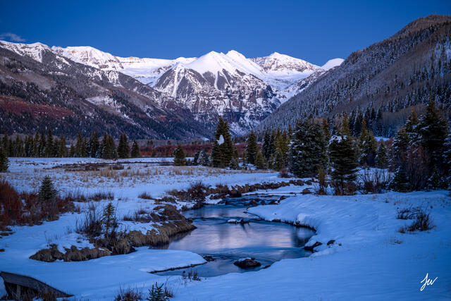 A snowy winter scene in Telluride, Colorado with mountains and alpine landscape