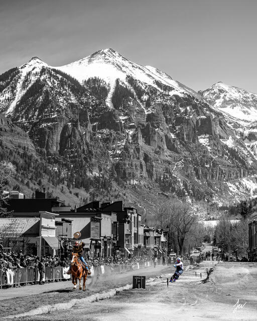 Skier being pulled by a horse during skijoring in Telluride, Colorado.