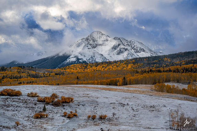 Wilson Mesa near Telluride, Colorado, dusted with fresh snow and surrounded by vibrant fall colors.