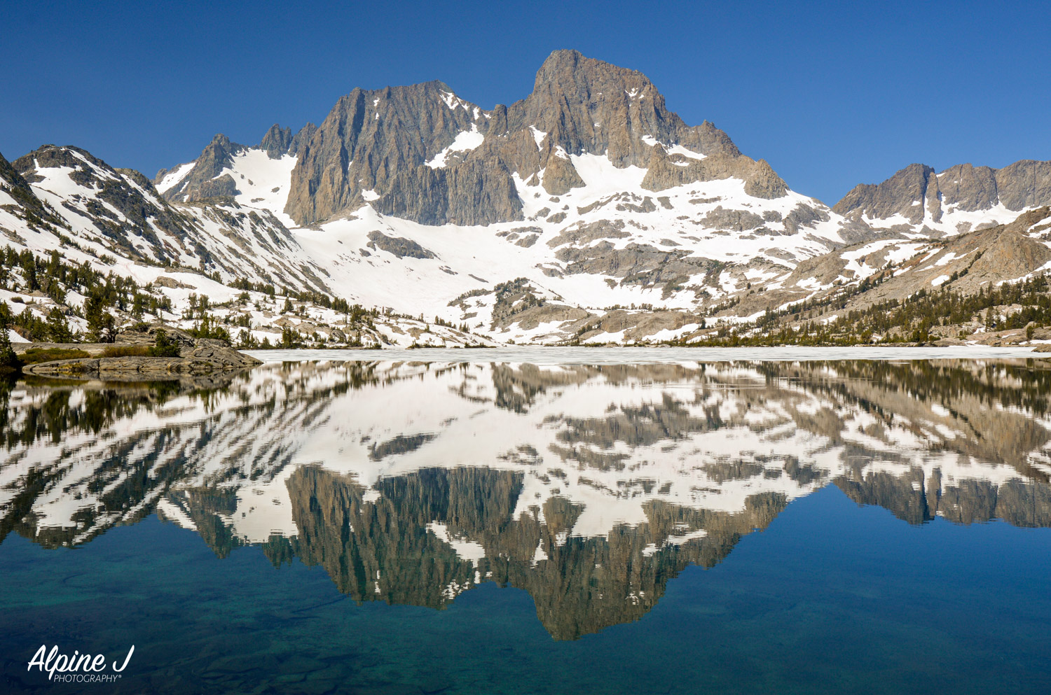 Alpine lake reflection in the Sierra Nevada in California.