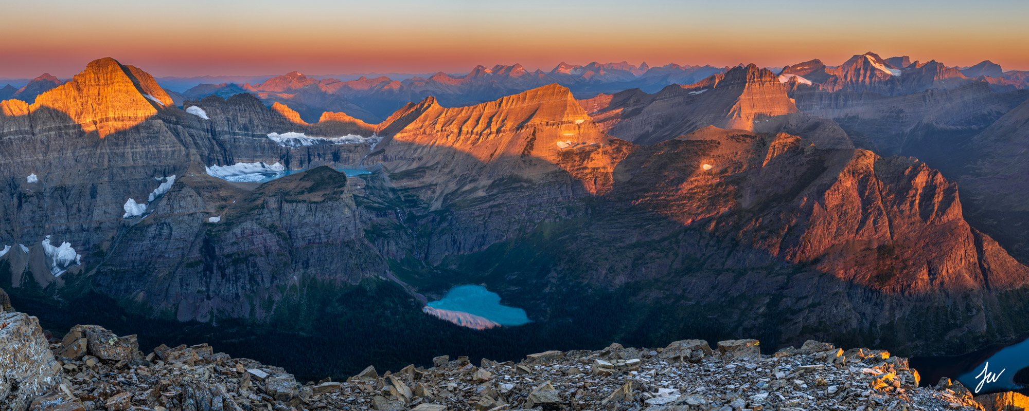 Sunrise over Grinnell Glacier as seen from a high mountain in Glacier National Park, Montana.