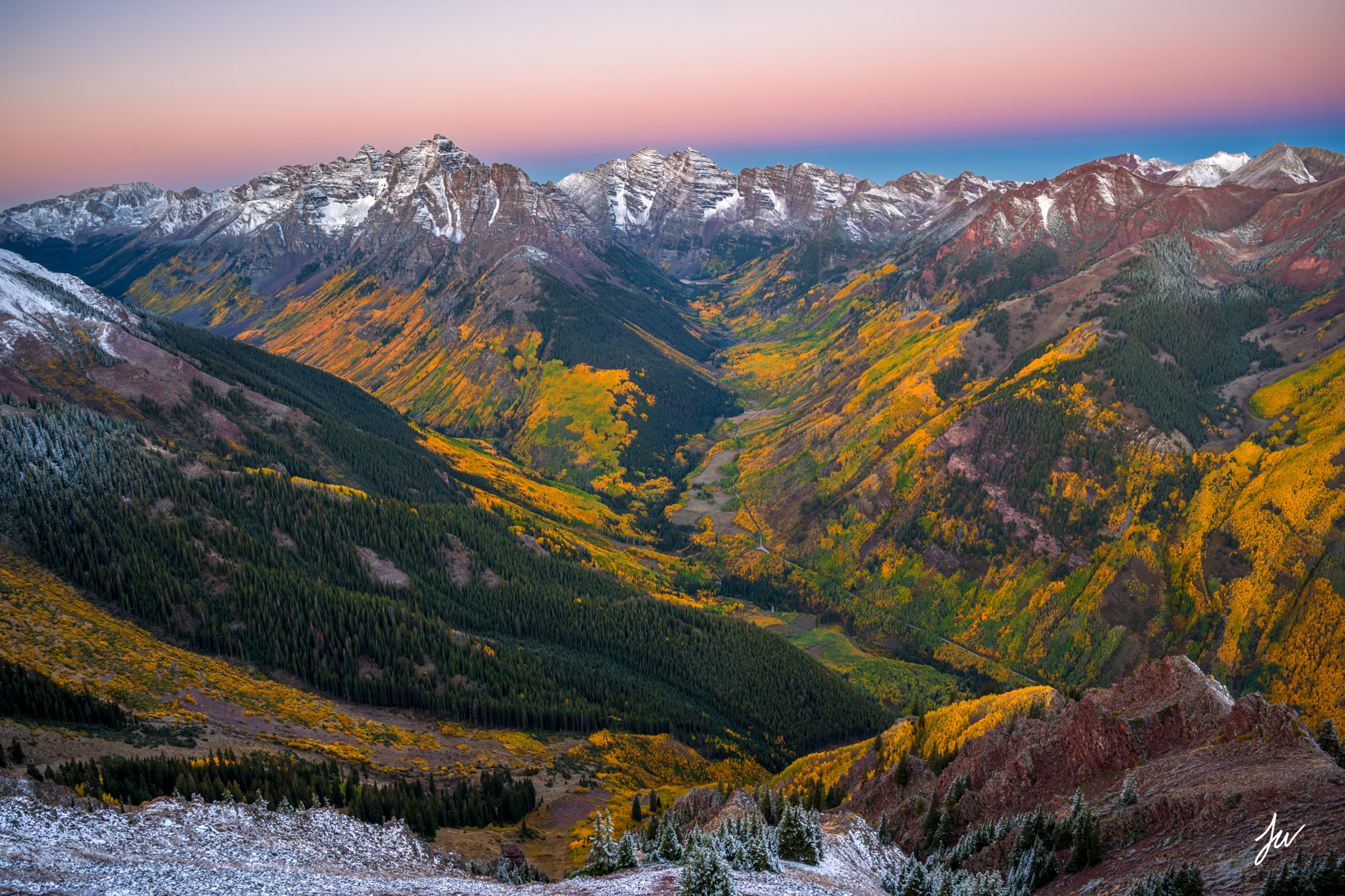 The Bells in Gold Maroon Bells surrounded by vibrant golden aspen trees during peak autumn color in Colorado.