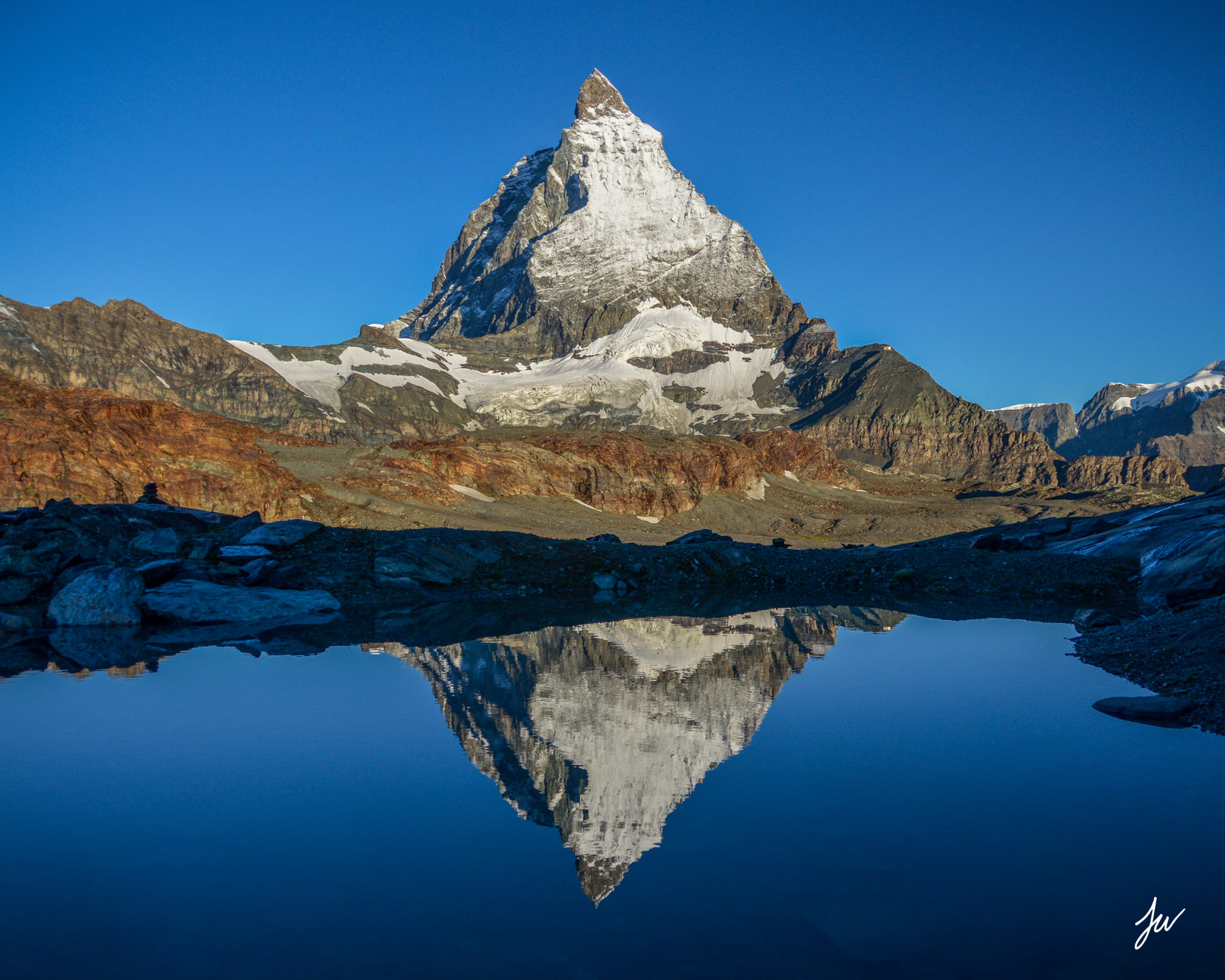 Matterhorn reflected in an alpine lake in Switzerland. 